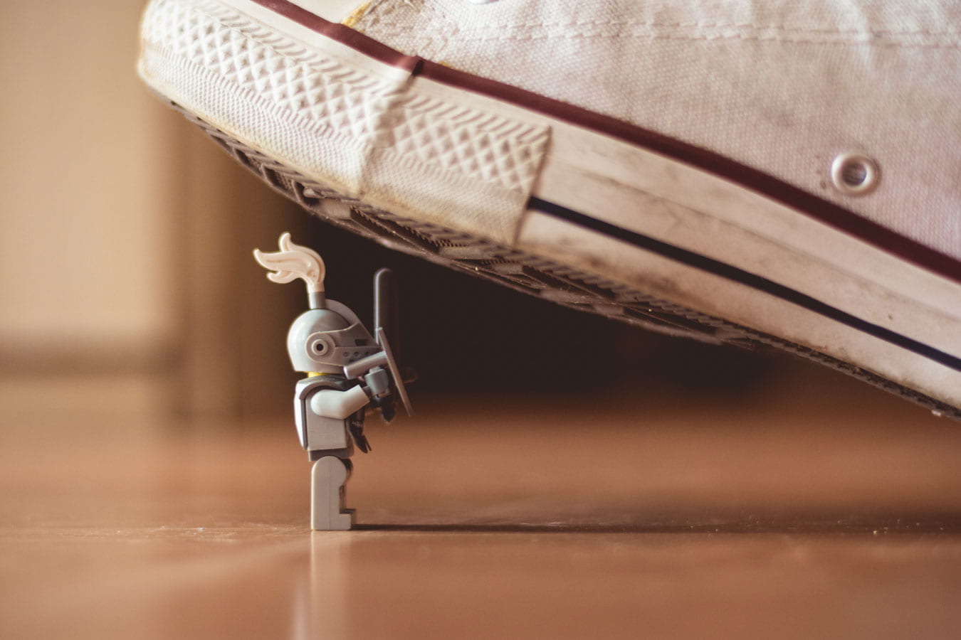 Close up shot of a lego knight almost being stepped on by a converse shoe