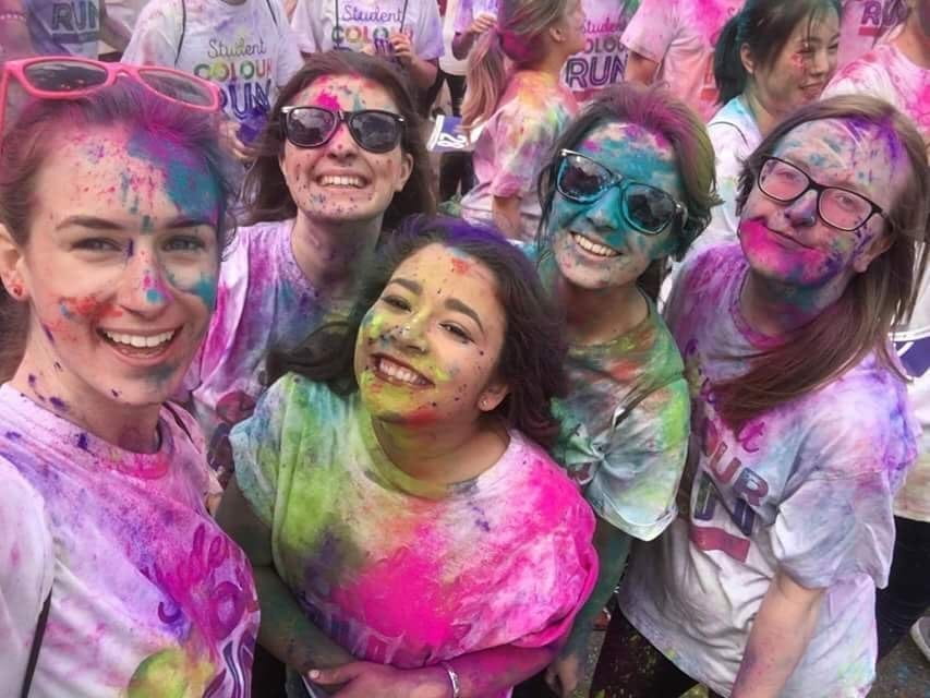 Group of students taking part in the colour run 2017, covered in paint.