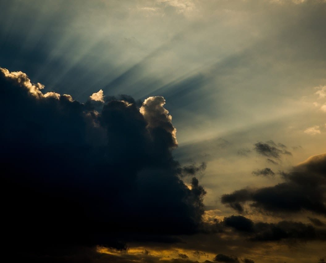 A cloudy sky with light rays