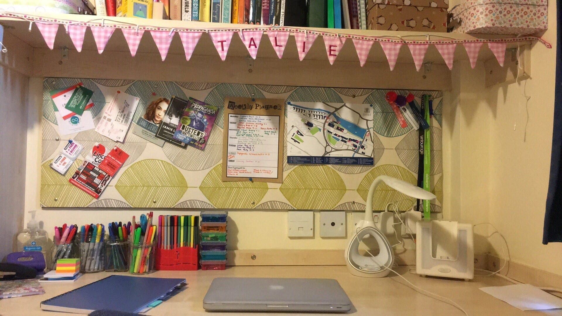 Students desk at home, with stationery and a laptop.