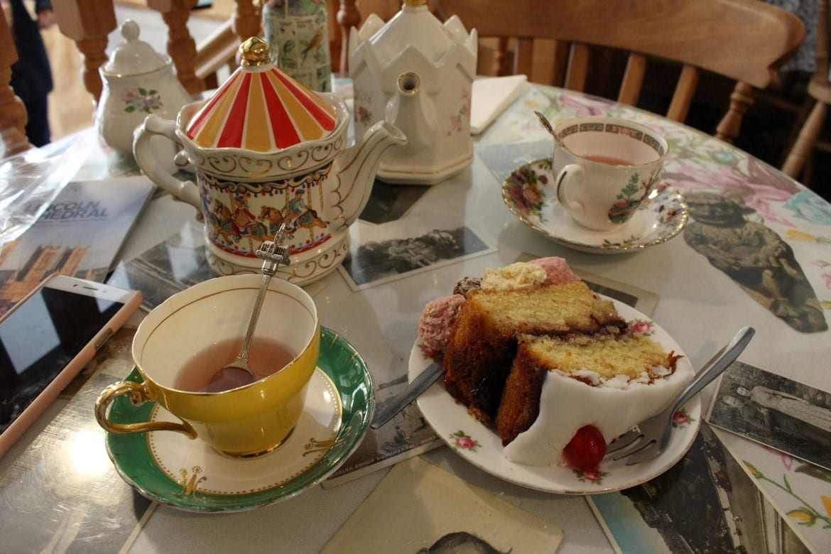 picture of tea and cake with china cups and china cutlery