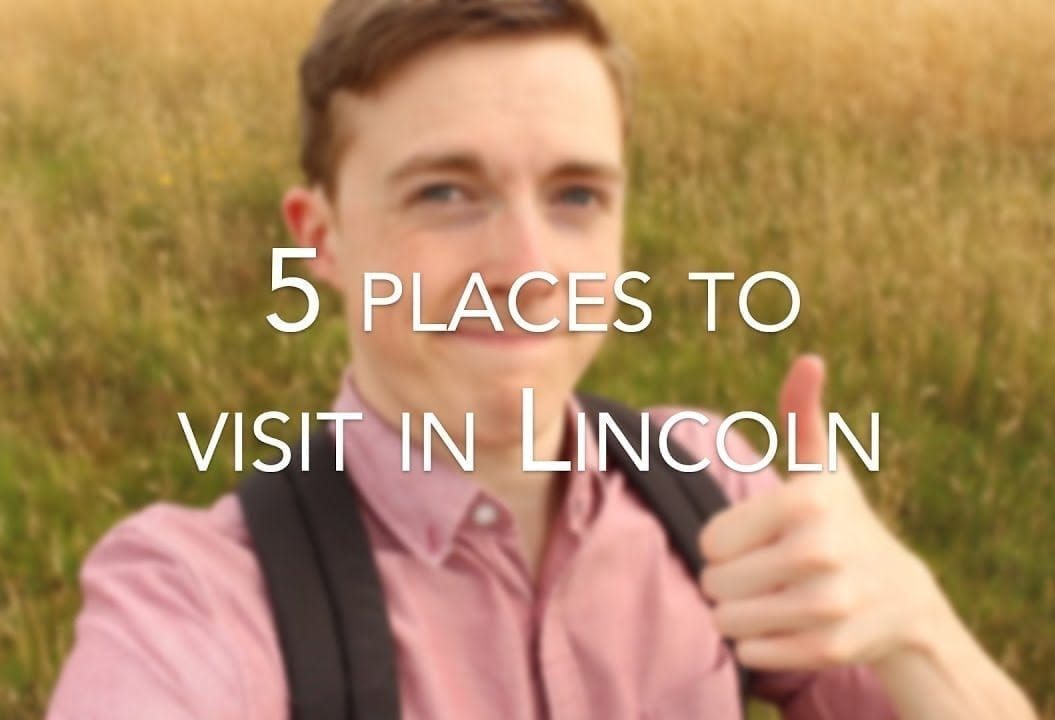 A young man stands in a field and holds his thumb up to the camera with the caption '5 Places to visit in Lincoln'