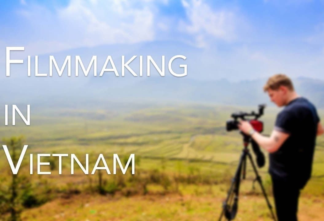 A man filming in the mountains, saying 'Filmmaking in Vietnam'