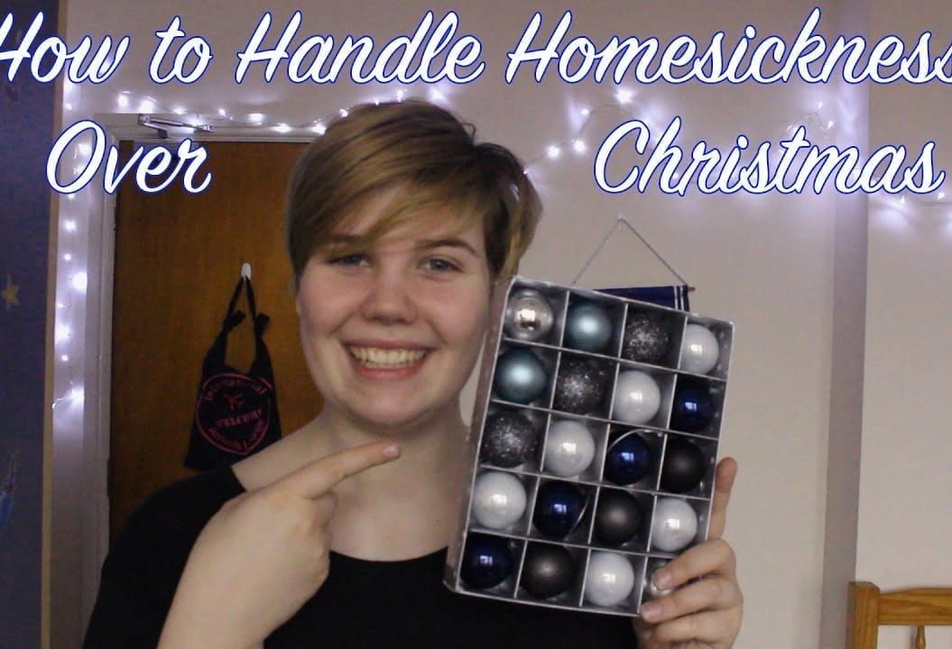 Thumbnail of girl smiling holding baubles, saying 'how to handle homesickness over Christmas'
