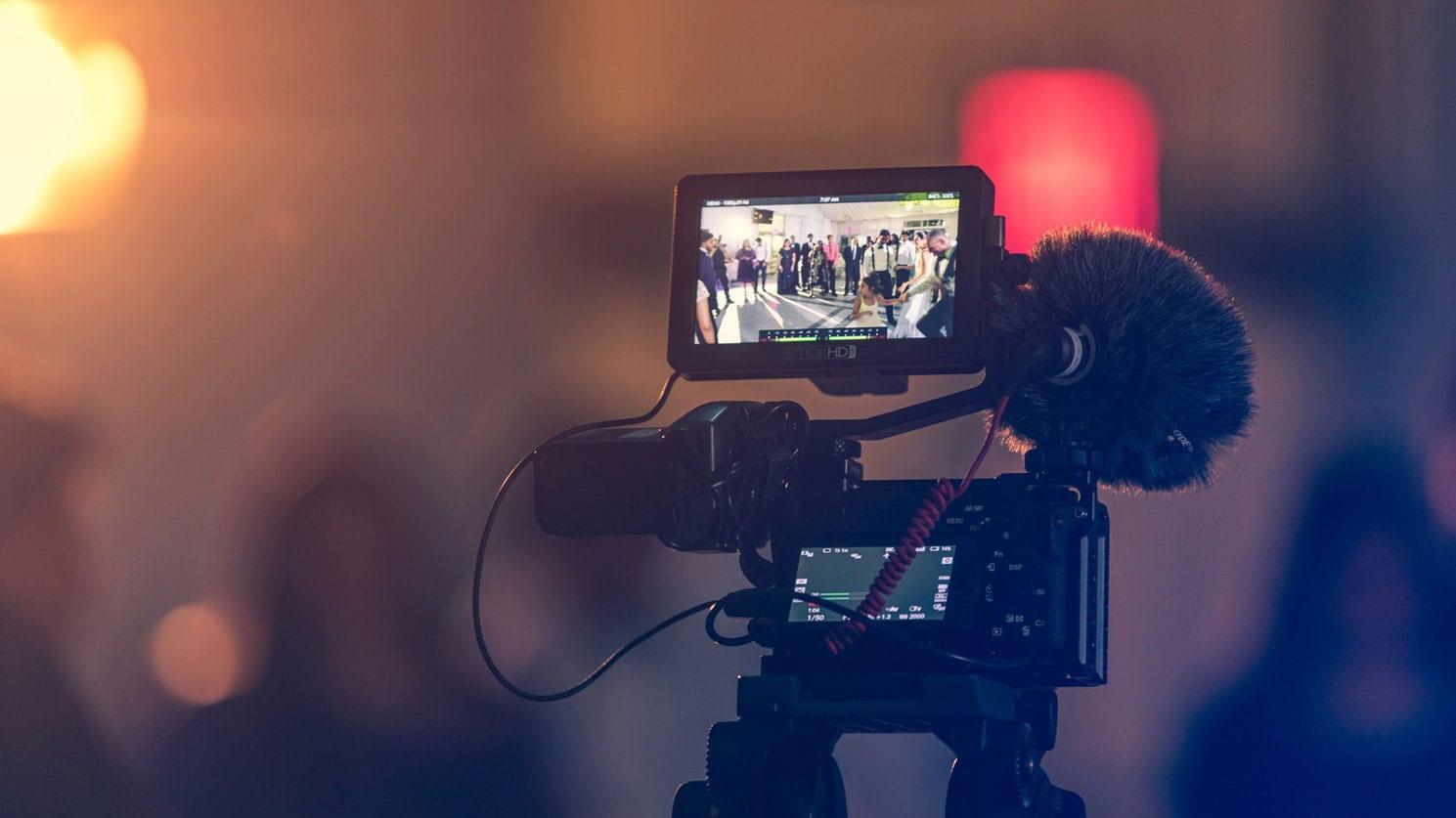 A camera filming a scene with a blurred background