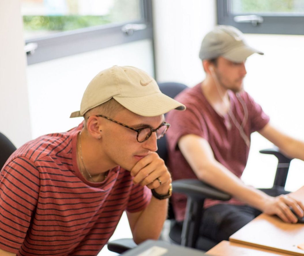 Image of two male students working on computers