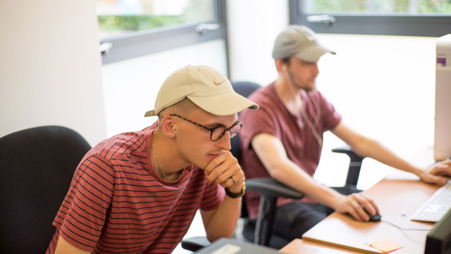 Image of two male students working on computers