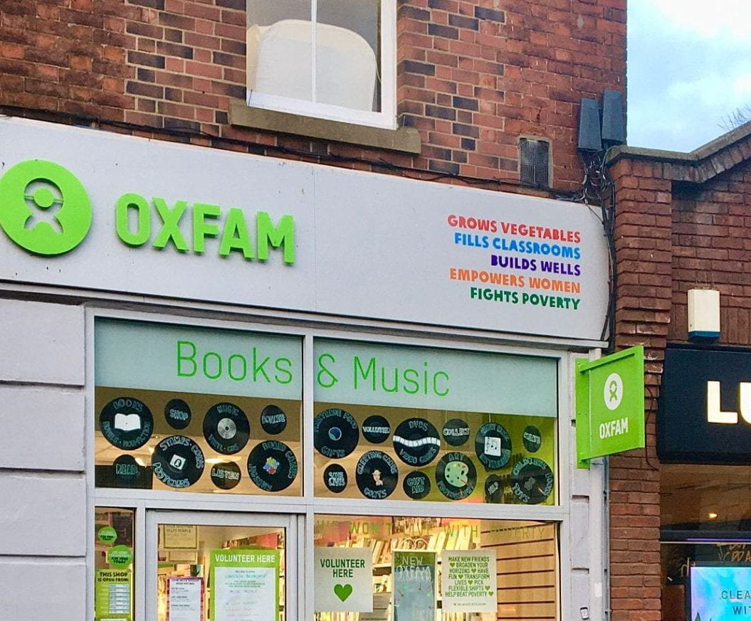 oxfam shop with 'book and music' in the window, next to a lush