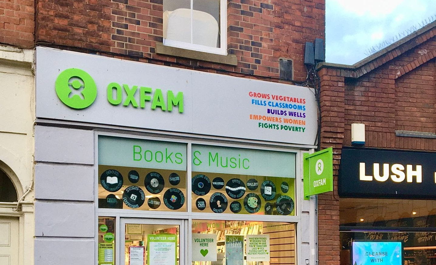 oxfam shop with 'book and music' in the window, next to a lush