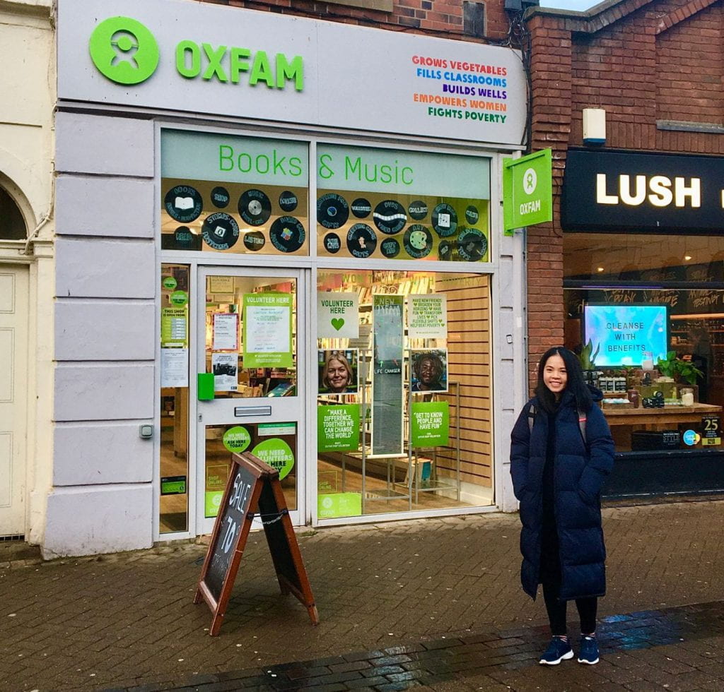 Chi, MA Education student from Vietnam standing outside Oxfam charity shop in Lincoln
