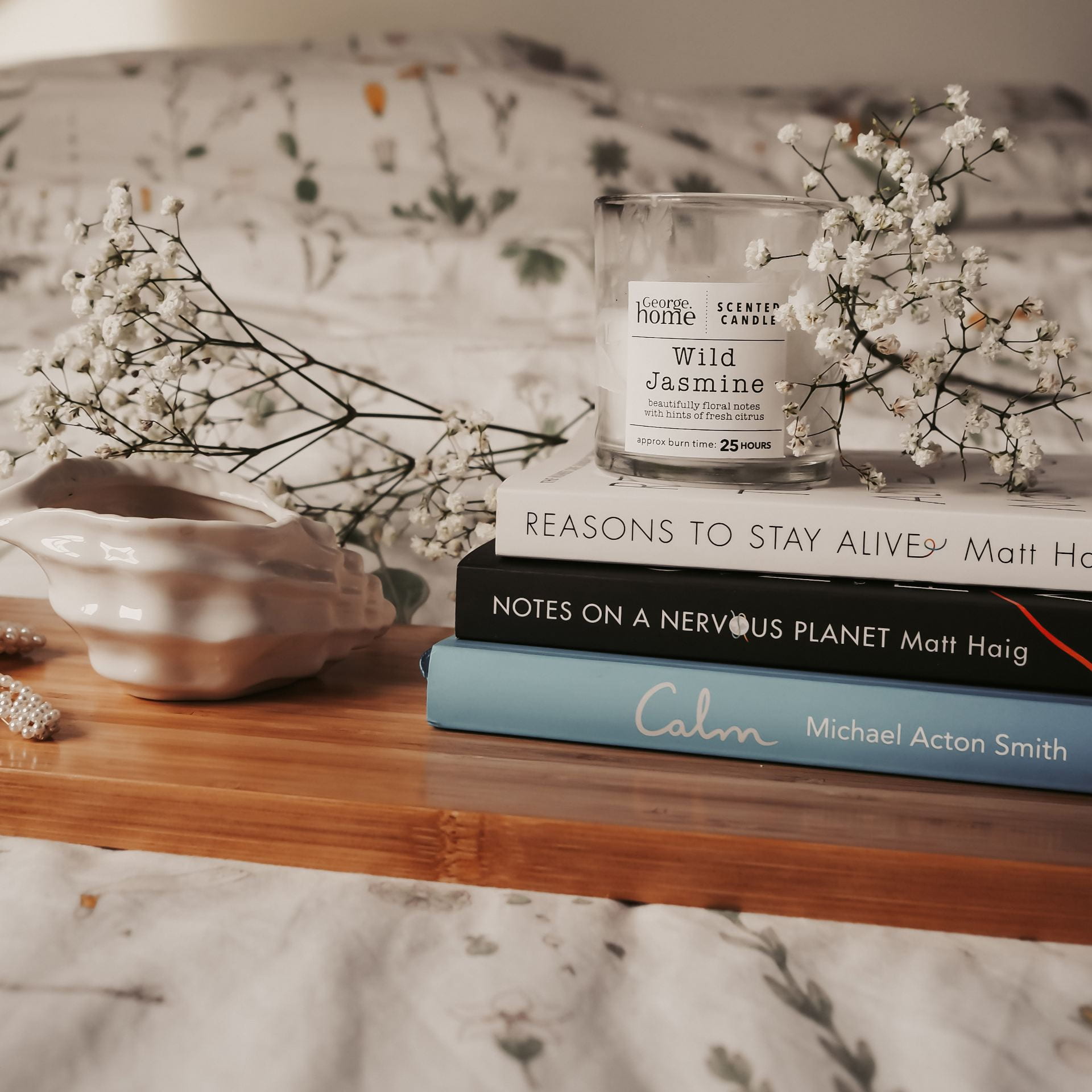Pile of books, flowers and a candle