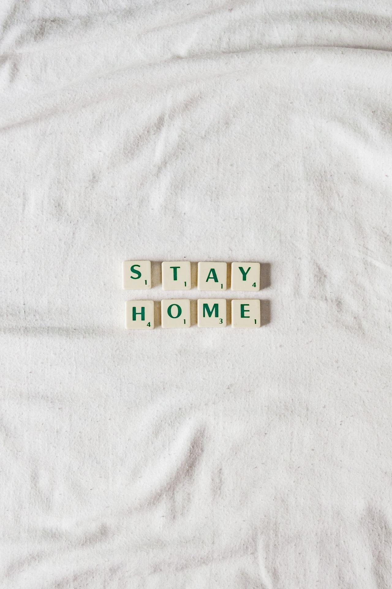 scrabble letters reading the words: stay home