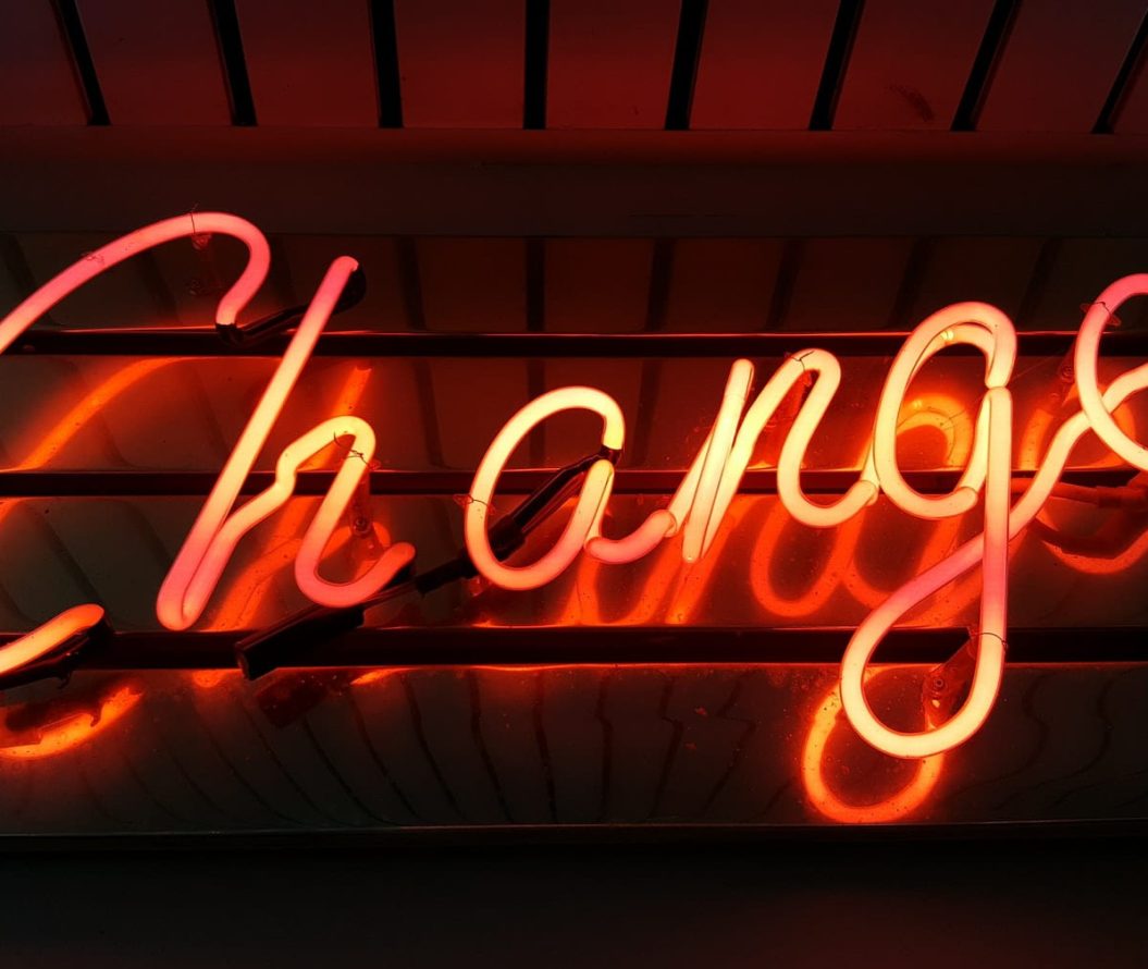 A neon sign that reads Change