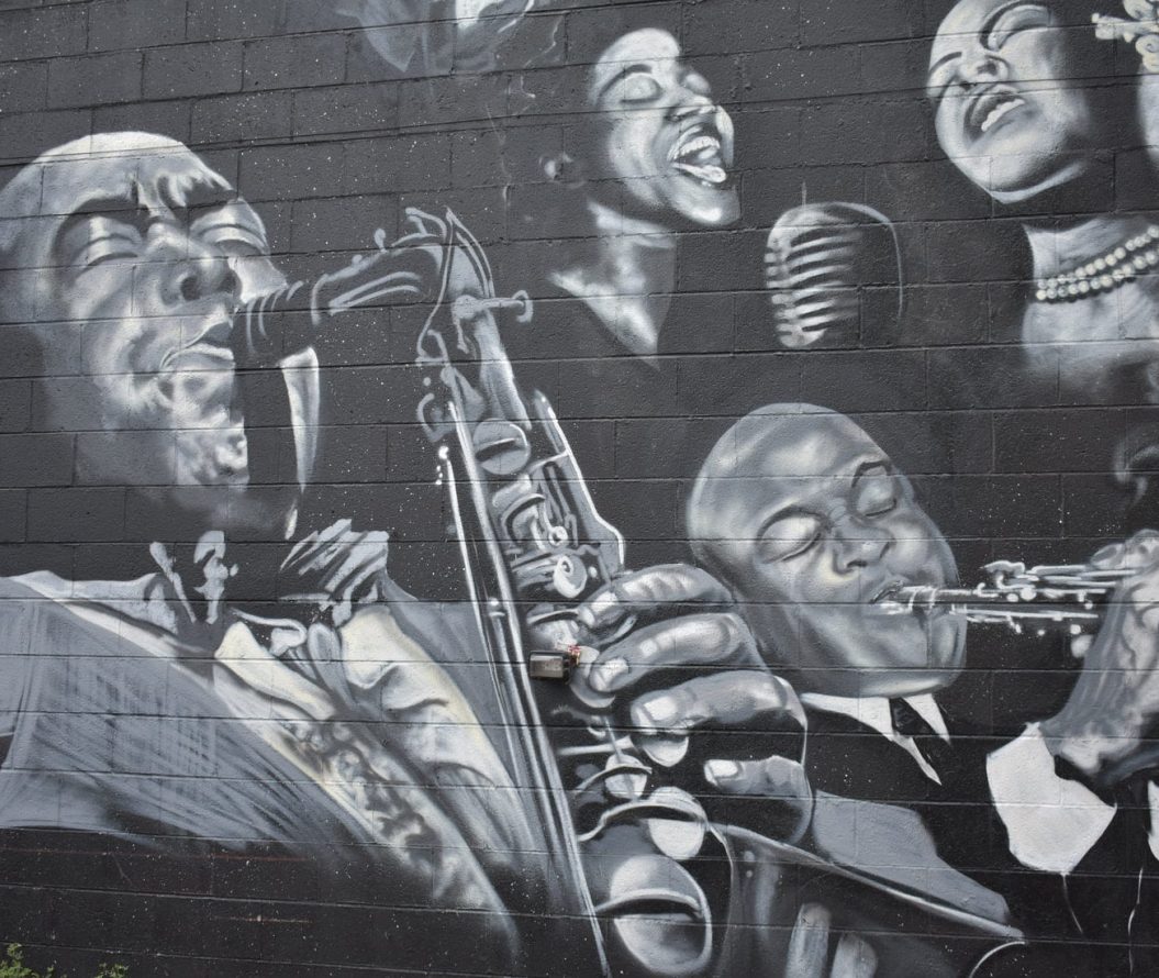 Black and white drawing on a wall of black musicians