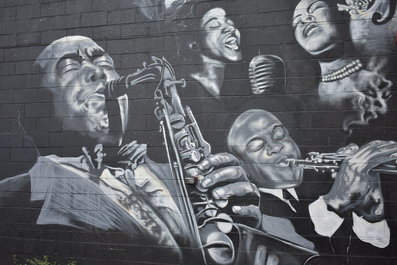 Black and white drawing on a wall of black musicians