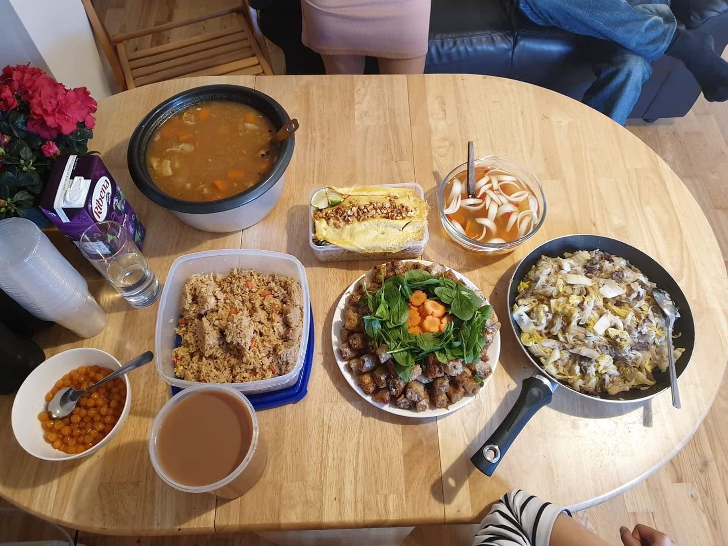 Kitchen table showing a variety of homecooked dishes ready to be shared