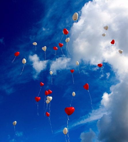 Heart shaped red and white balloons in the sky