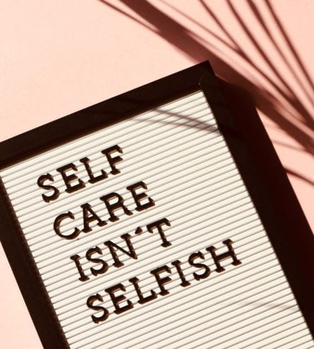 A board that reads 'self care isn't selfish'