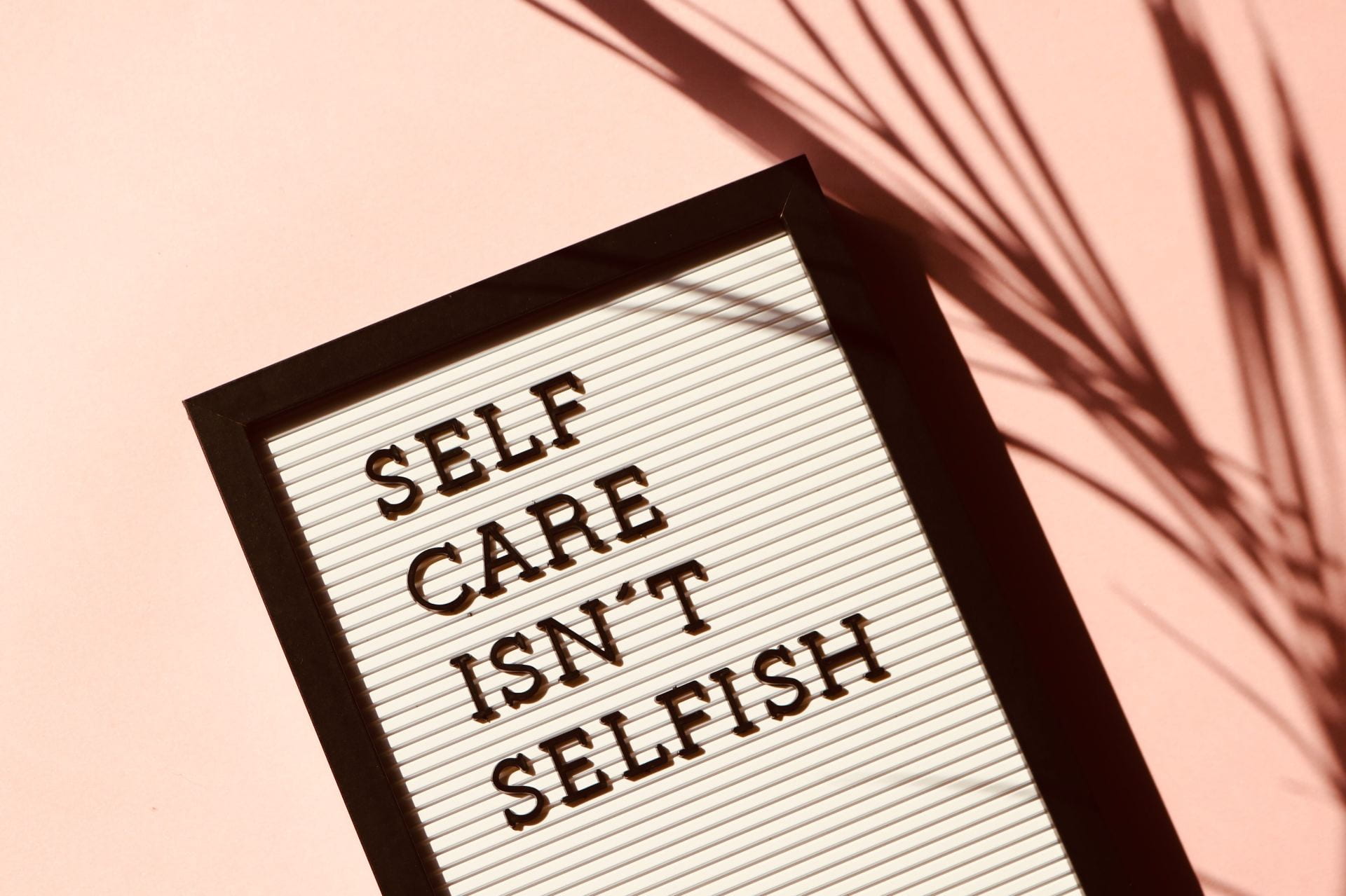 A board that reads 'self care isn't selfish'