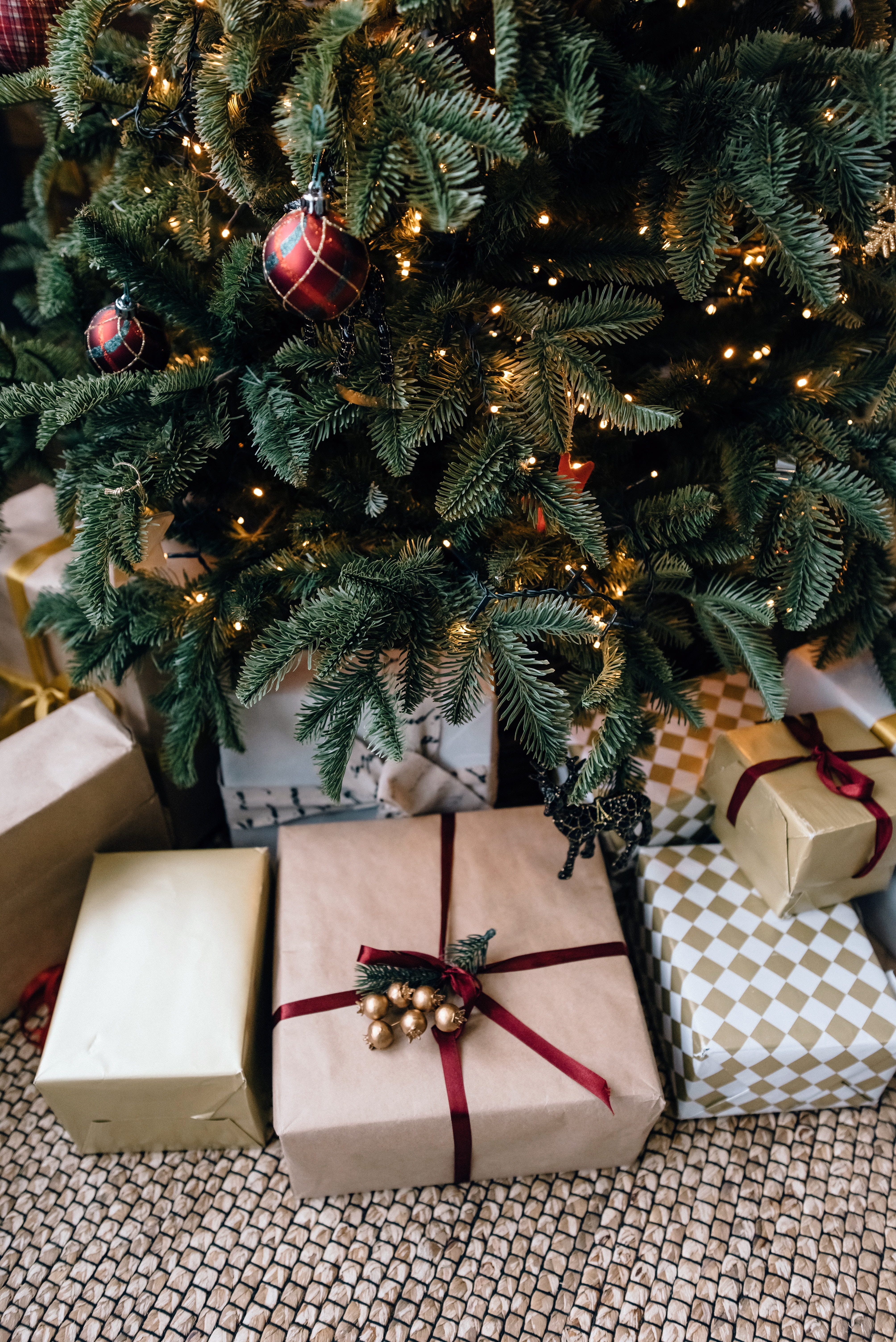 Close up of presents under a tree, wrapped in brown paper.