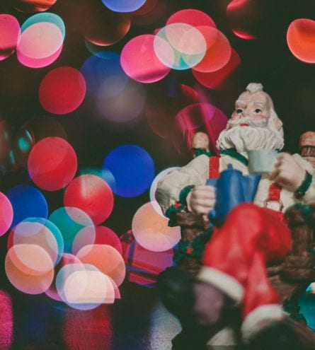 Close up of a santa figure with blurred lights surrounding