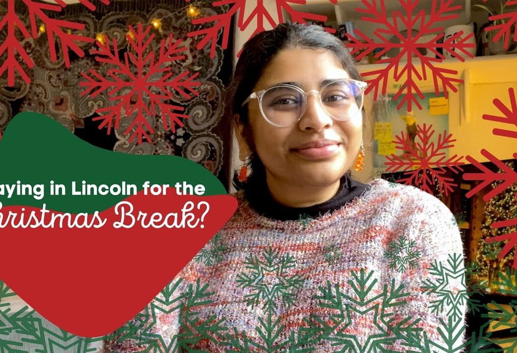 Shahinah centred surrounded by red snow flake graphics with text reading 'Staying in Lincoln for the Christmas Break?'