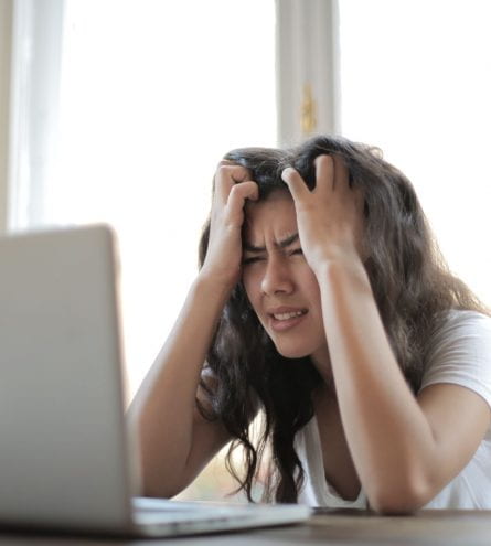 A woman stressed staring at her laptop