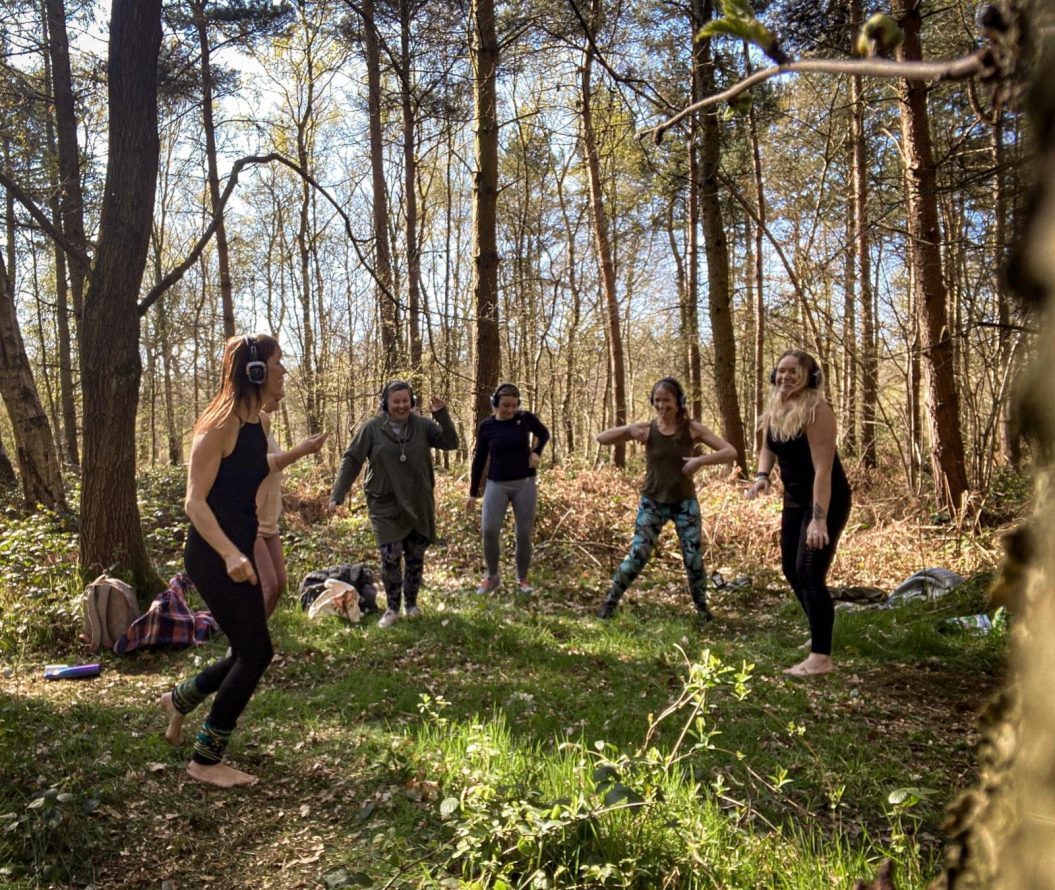 A group of people dancing in the woods