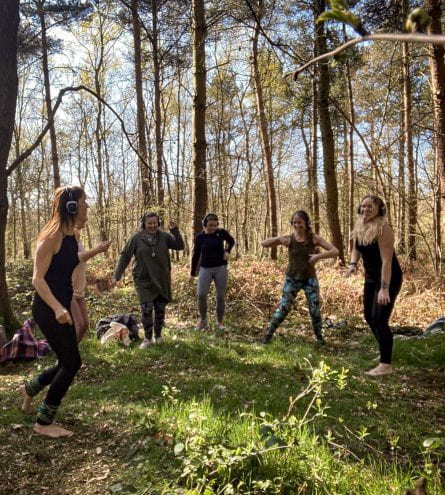 A group of people dancing in the woods