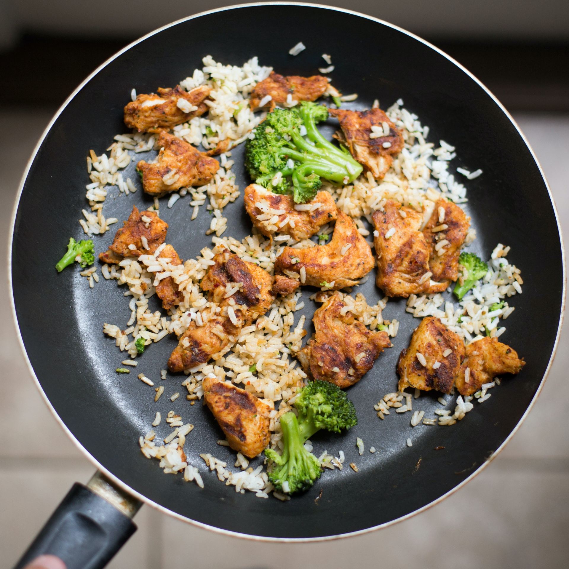 Chicken, rice and broccoli in a frying pan