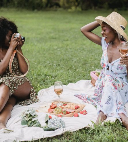 Two women sat having a picnic