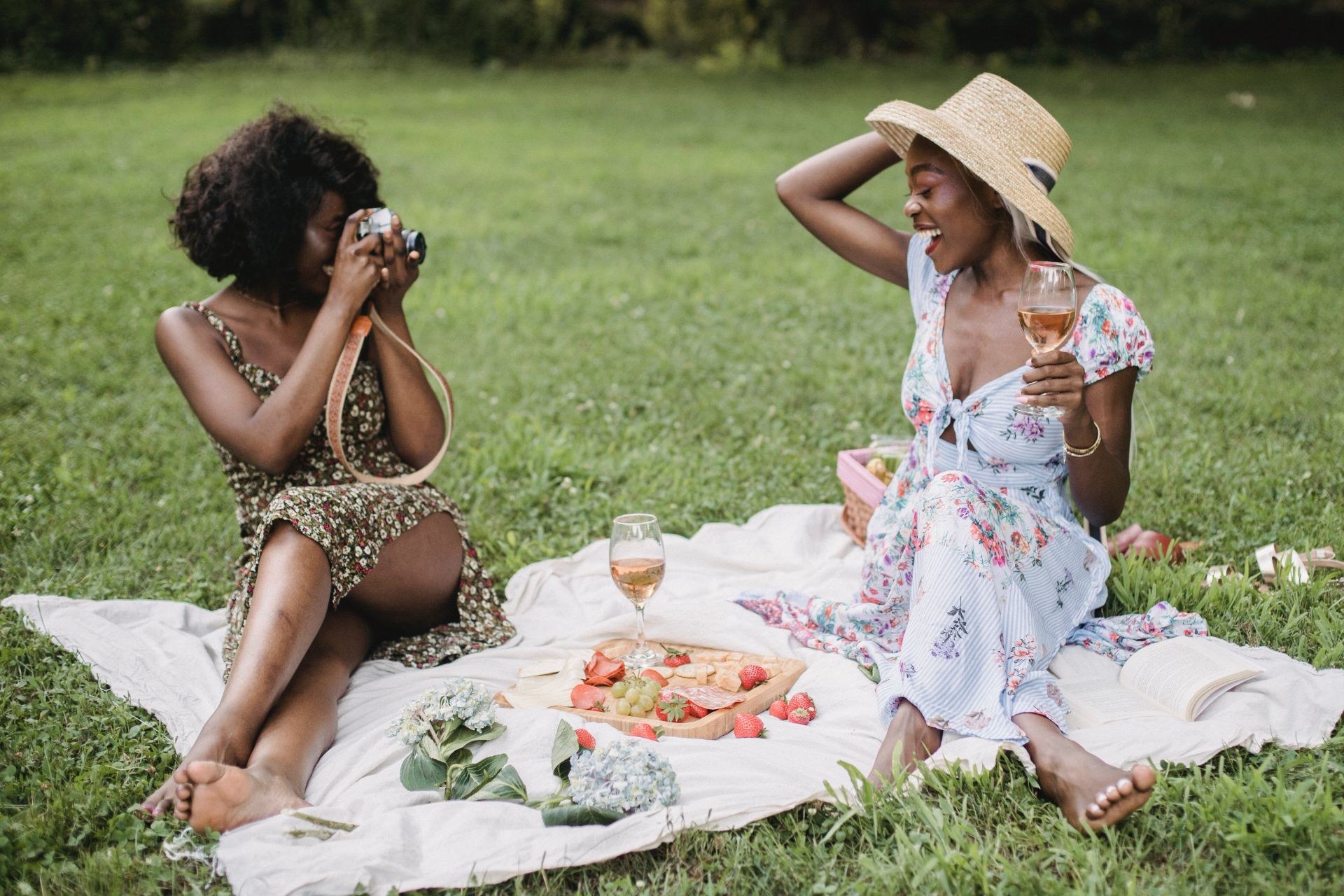 Two women sat having a picnic