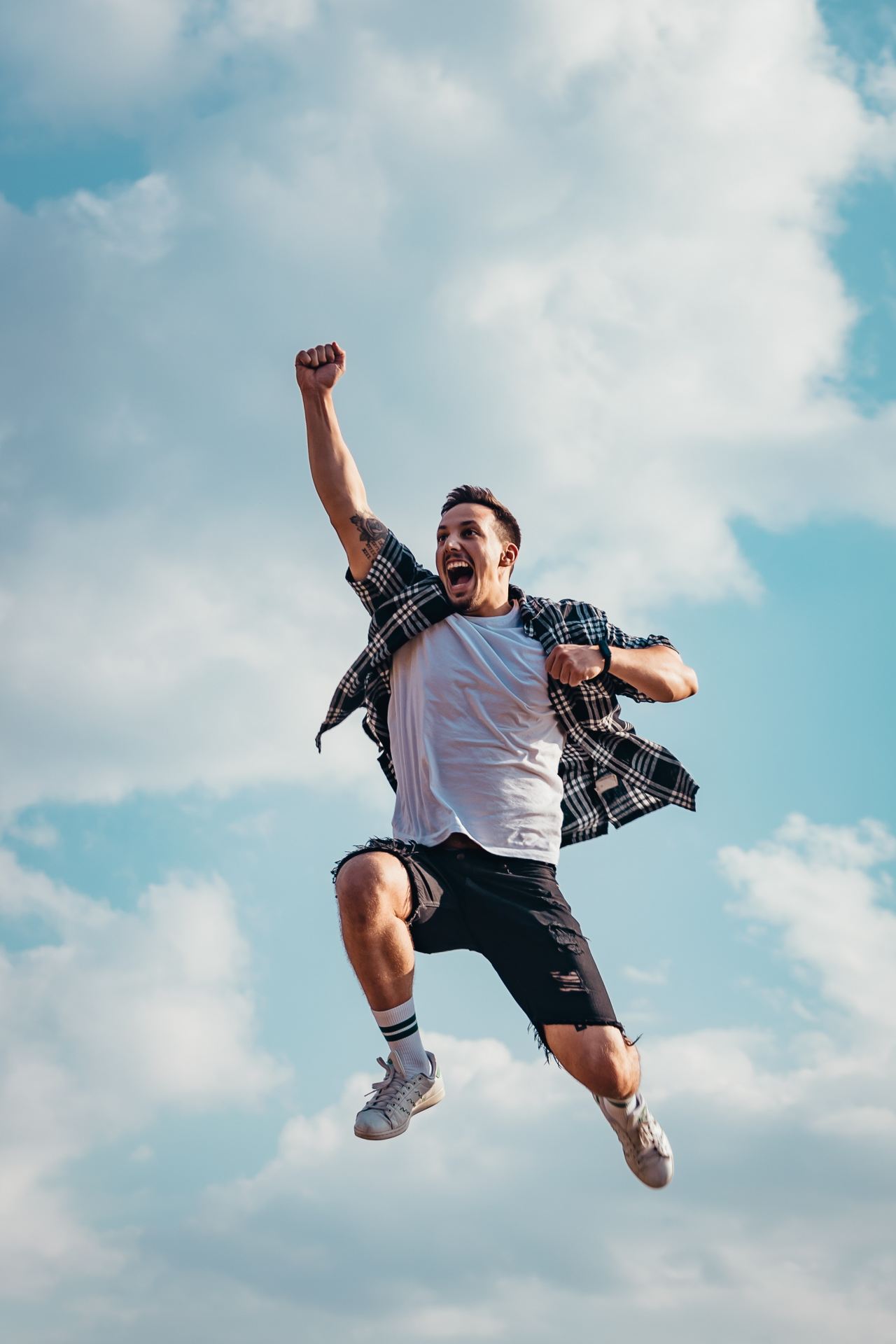 Man jumping happily with fist in air