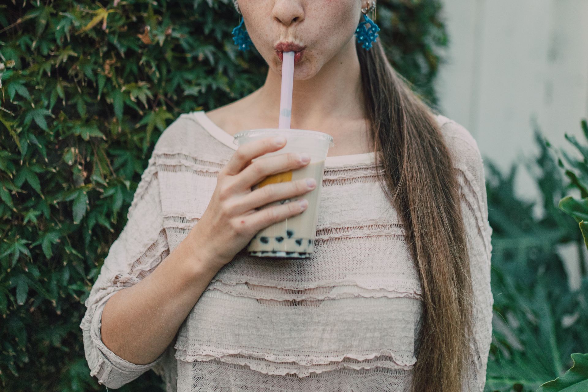 A person drinking boba tea