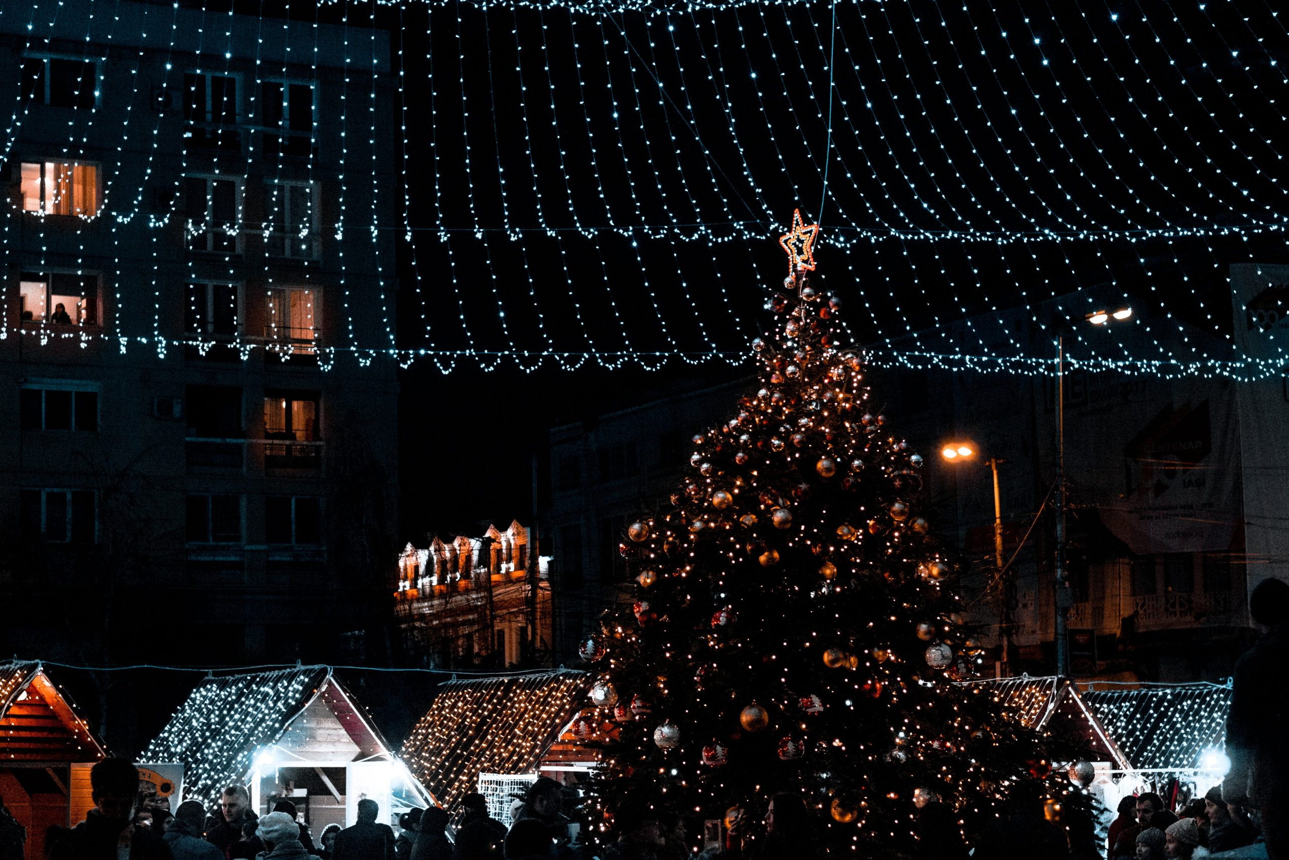 Christmas Tree, lights and market stalls.
