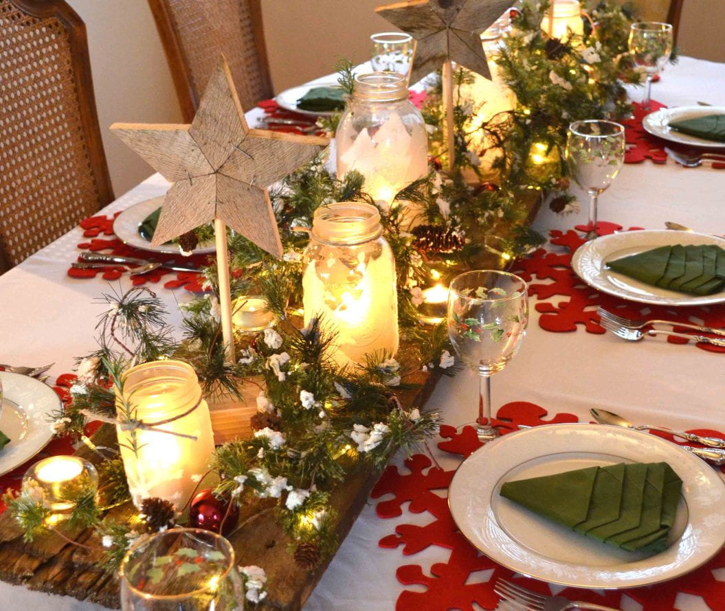 A dining table set up with Christmas decorations.